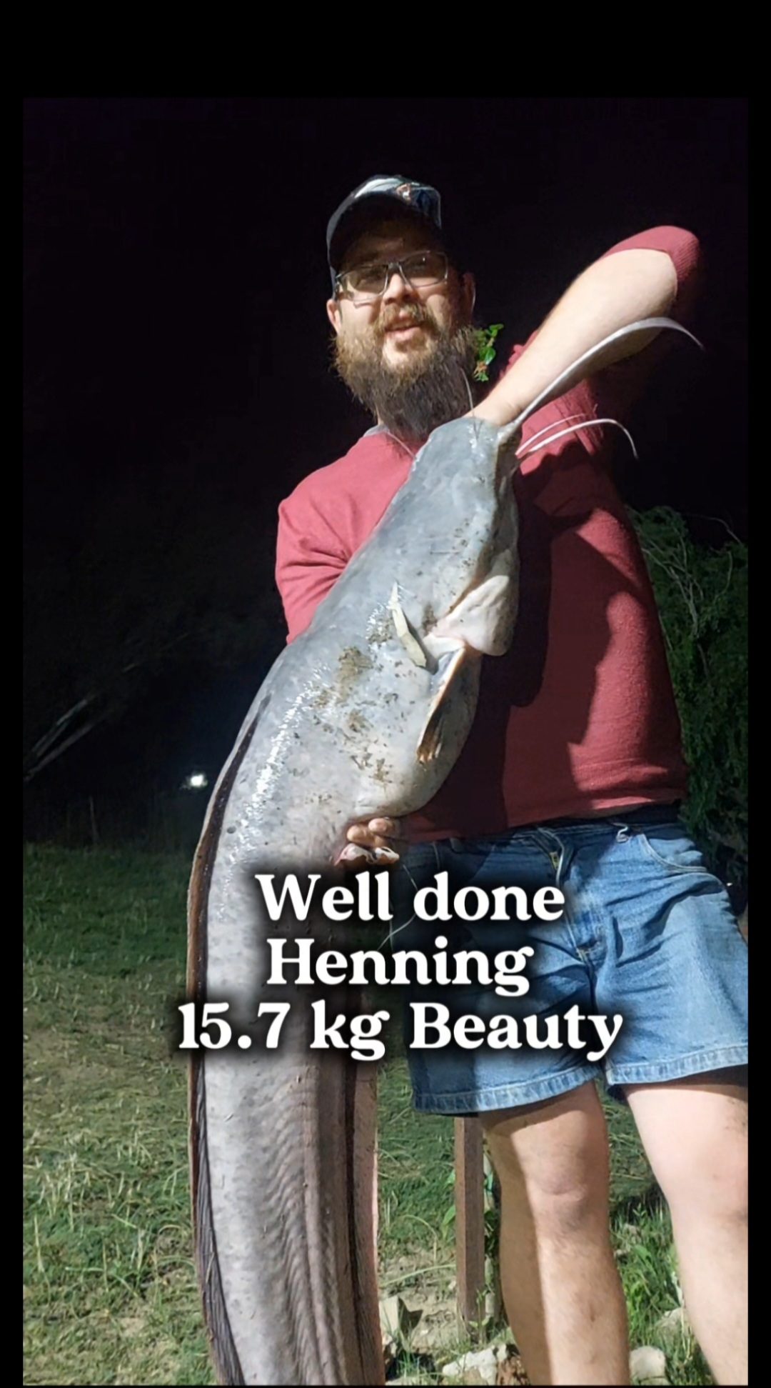 Henning holding his 15.7kg catfish at night